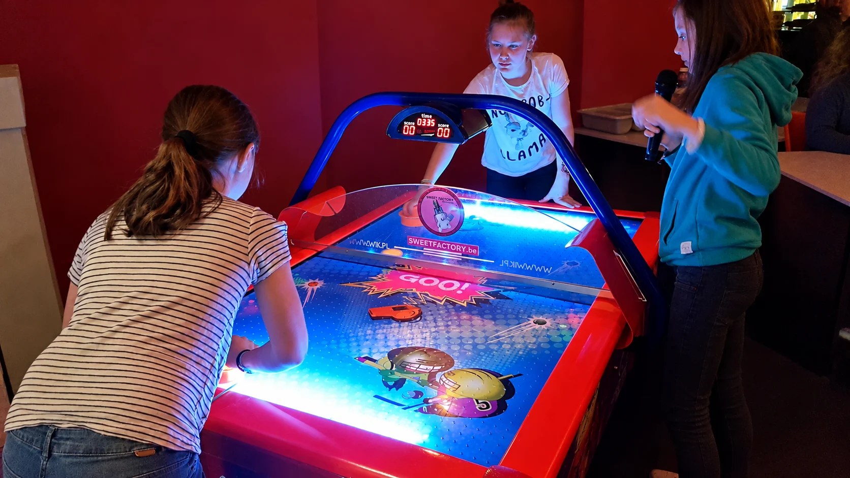 Kinderen spelen samen airhockey tijdens het slaapfeestje